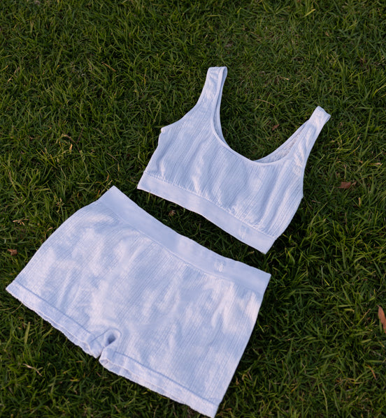 Blue Pretty Kitty Klub Comfy Kitty Set top and matching shorts laid flat on green grass.