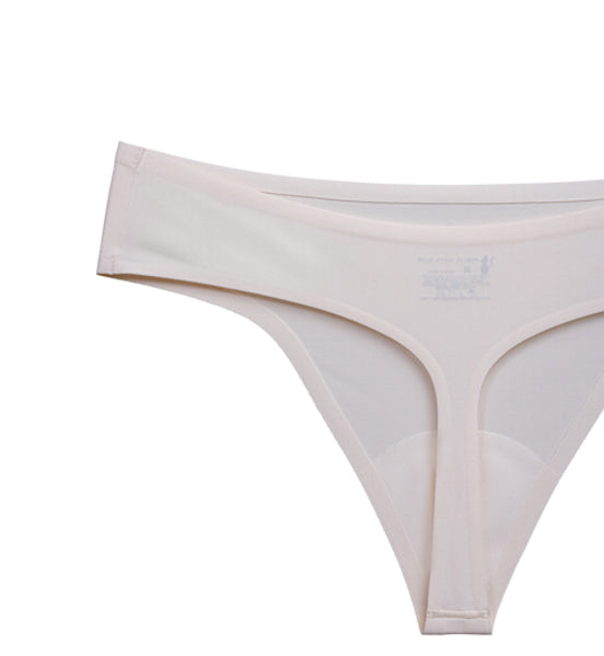 Flat-lay image of Pretty Kitty Klub Crème Meow cream thong underwear showing its shape and construction.