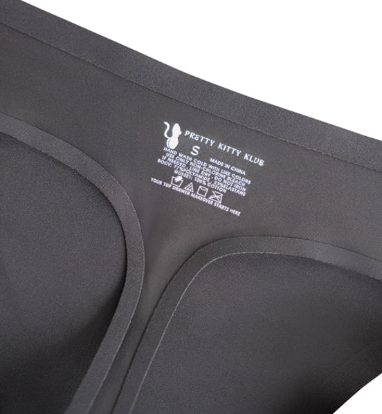 Close-up of Pretty Kitty Klub black thong underwear showing bonded edges and interior garment branding.
